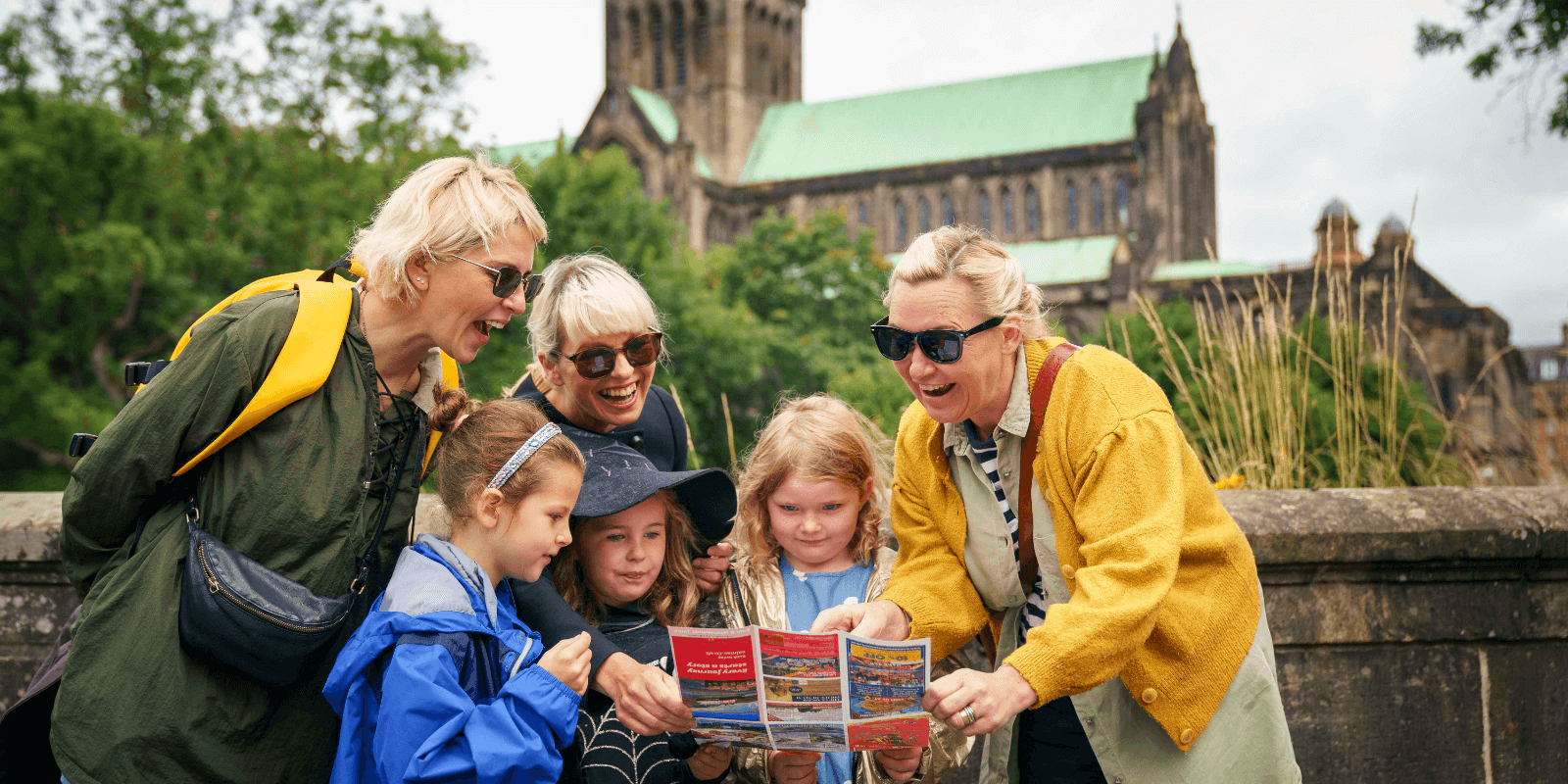 Tourists smiling while looking at tour map